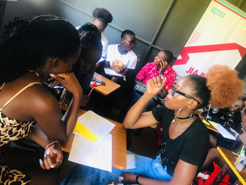 Ganjisha students engaged in a group discussion during a content creation workshop